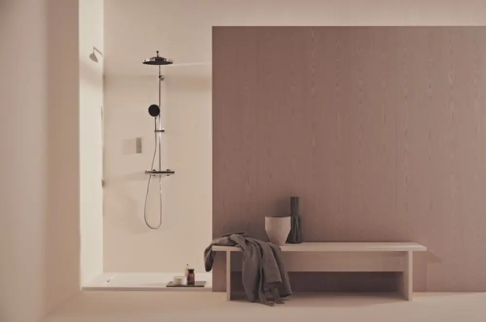 Duschsystem von Ideal Standard in moderner Einrichtung, bestehend aus Wandpaneel und Duschkopf, integriert in einen minimalistisch gestalteten Raum mit Holzoberflächen.